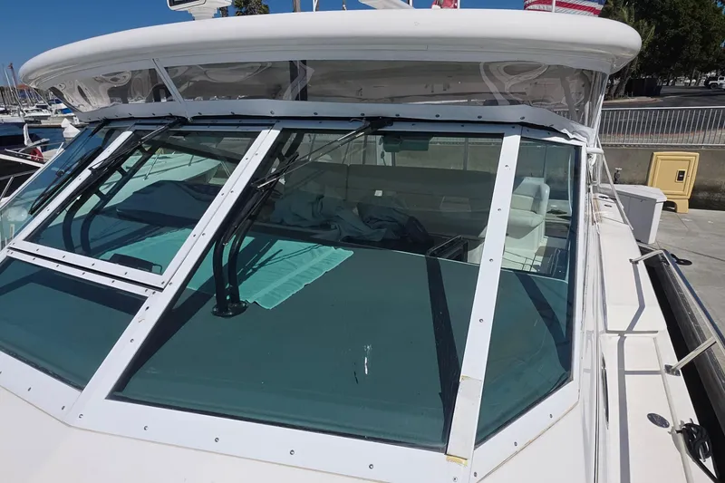 Slide: The Image of 2004 Tiara Yachts 4000 Express boat with clear windshield and docked at marina. - 22