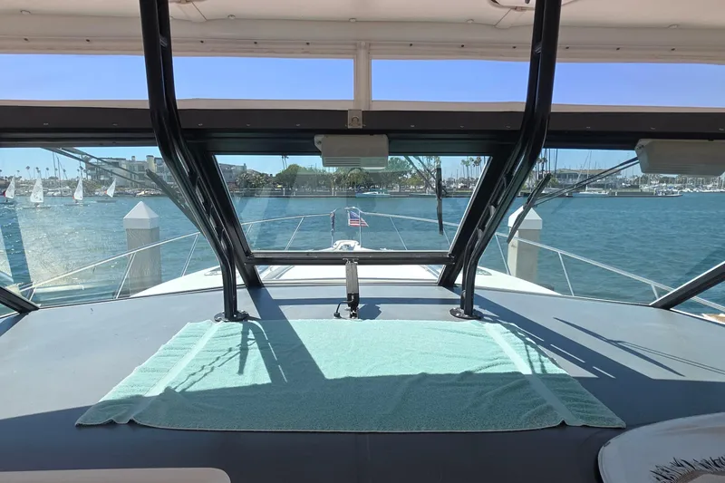 Slide: The Image of 2004 Tiara Yachts 4000 Express interior view with marina backdrop. - 23