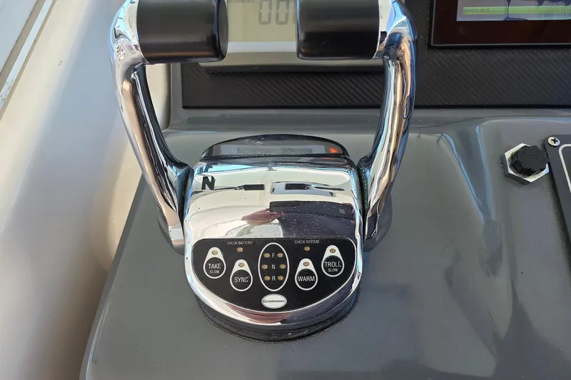 Slide: The Image of Throttle controls on a 2004 Tiara Yachts 4000 Express boat dashboard. - 25