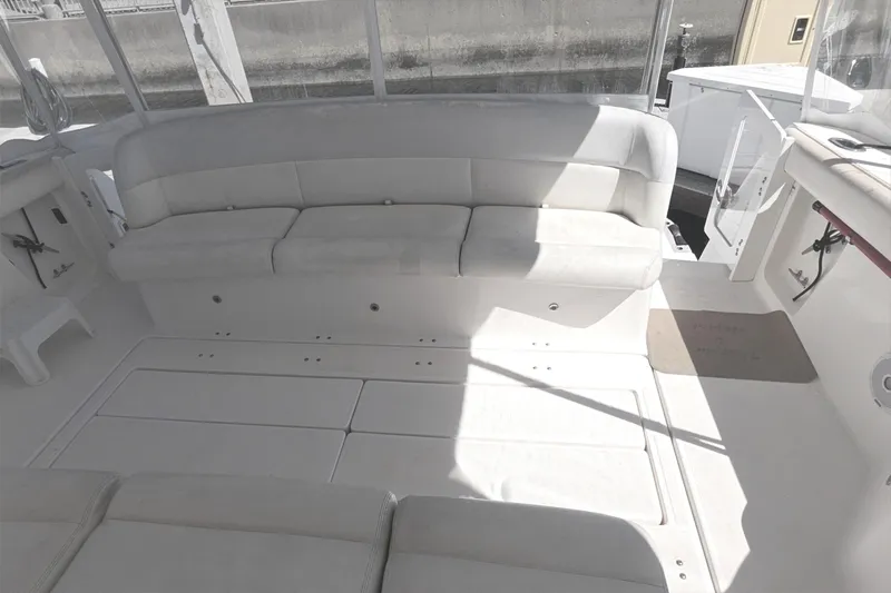 Slide: The Image of 2004 Tiara Yachts 4000 Express interior with white seating and spacious deck area. - 33