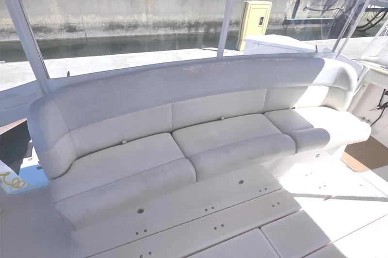 Slide: The Image of 2004 Tiara Yachts 4000 Express boat seating area with cushioned bench. - 39