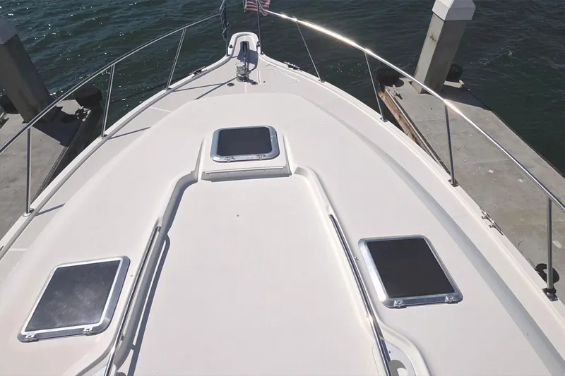 Slide: The Image of Bow view of 2004 Tiara Yachts 4000 Express docked by the water. - 41