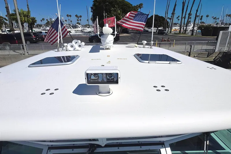 Slide: The Image of 2004 Tiara Yachts 4000 Express boat roof with flags and equipment in marina setting. - 44