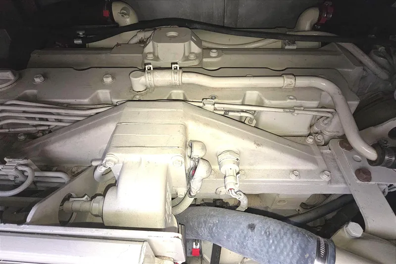 Slide: The Image of Engine compartment of a 2004 Tiara Yachts 4000 Express, showcasing mechanical components and hoses. - 46