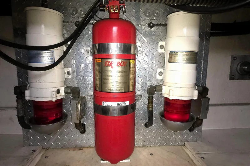 Slide: The Image of Engine room of 2004 Tiara Yachts 4000 Express with fire extinguisher and fuel filters. - 54