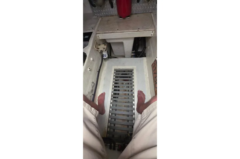 Slide: The Image of Interior view of a 2004 Tiara Yachts 4000 Express engine room with visible grating. - 56