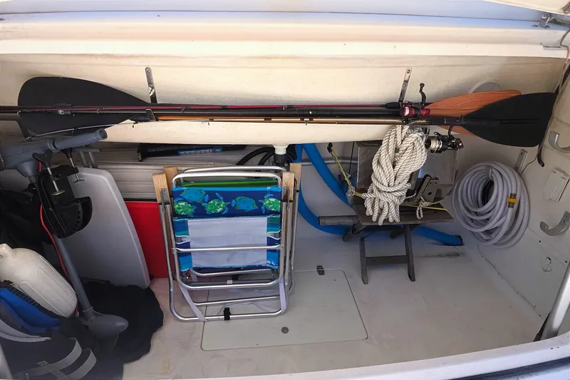 Slide: The Image of Storage compartment of a 2004 Tiara Yachts 4000 Express with fishing gear and boating equipment. - 58