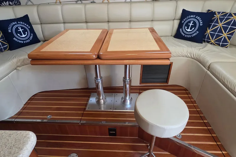 Slide: The Image of Interior of 2004 Tiara Yachts 4000 Express with elegant seating and wooden table. - 6