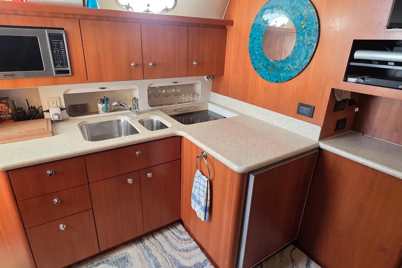 Slide: The Image of 2004 Tiara Yachts 4000 Express kitchen with wood cabinetry and modern appliances. - 8