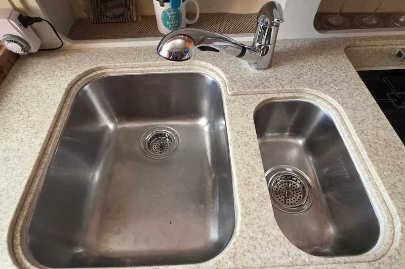 Slide: The Image of Dual stainless steel sinks in a 2004 Tiara Yachts 4000 Express kitchen. - 9