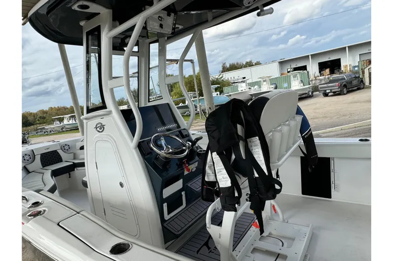 Slide: The Image of 2023 Tidewater 232 LXF boat interior with steering console and seating. - 4