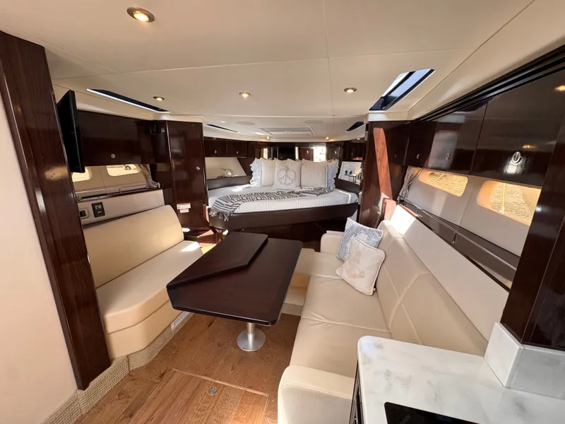 Slide: The Image of Interior of the 2018 Sea Ray Sundancer 350 with elegant furnishings and cozy seating areas. - 22