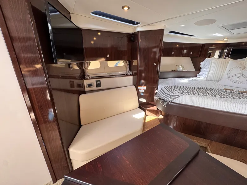 Slide: The Image of Interior of a 2018 Sea Ray Sundancer 350 with elegant wood finishes and cozy seating. - 30