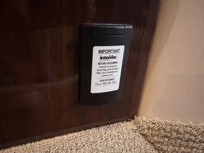 Slide: The Image of A black casing with a warning and phone number is mounted on a wall. - 37