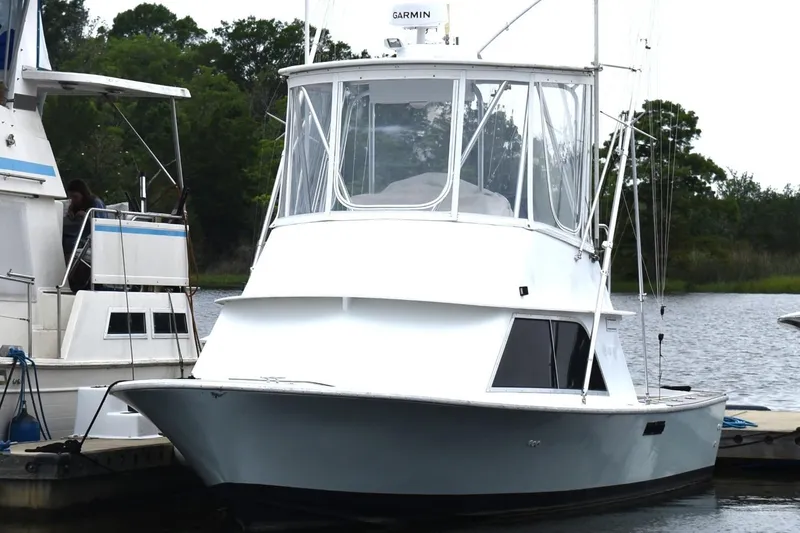 The Image of 1981 Blackfin 32 Sportfisherman boat docked, featuring a sleek design and enclosed cabin. - 1
