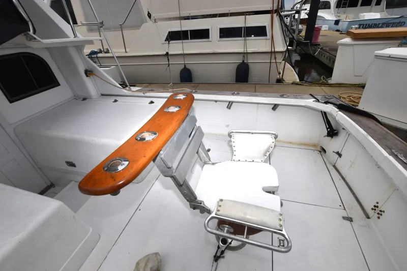 Slide: The Image of 1981 Blackfin 32 Sportfisherman cockpit with fishing chair and rod holders. - 5
