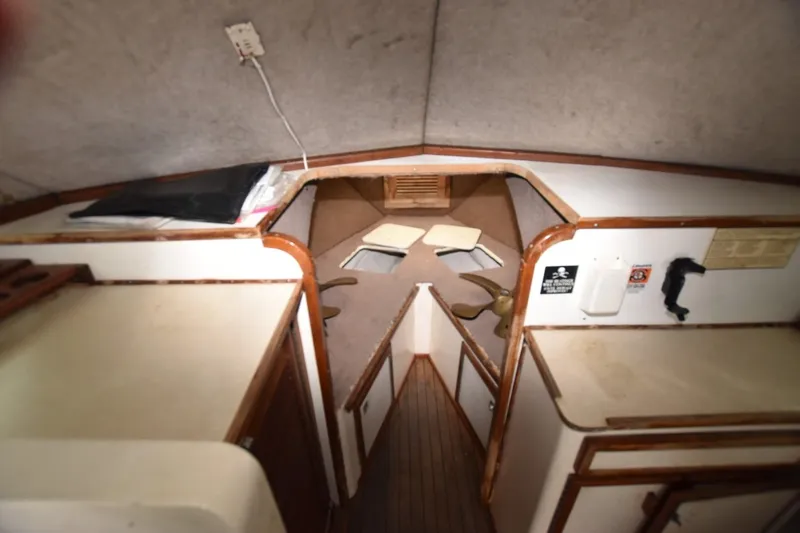 Slide: The Image of Interior cabin of a 1981 Blackfin 32 Sportfisherman boat, featuring wood accents and storage areas. - 6