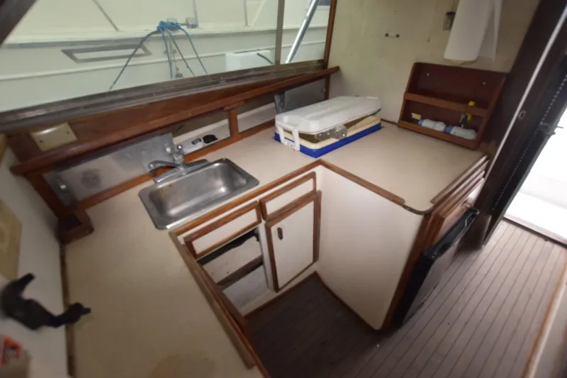Slide: The Image of 1981 Blackfin 32 Sportfisherman interior kitchen with sink and storage cabinets. - 7