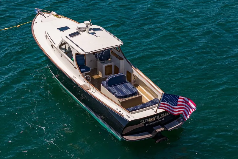 Slide: The Image of 2001 Hinckley Picnic Boat 36 Classic cruising on clear blue water. - 13