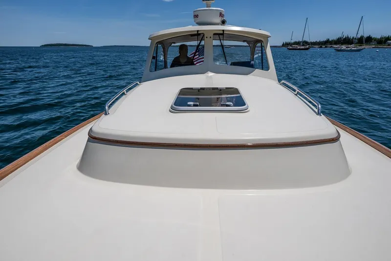 Slide: The Image of 2001 Hinckley Picnic Boat 36 Classic cruising on open water with clear skies. - 16