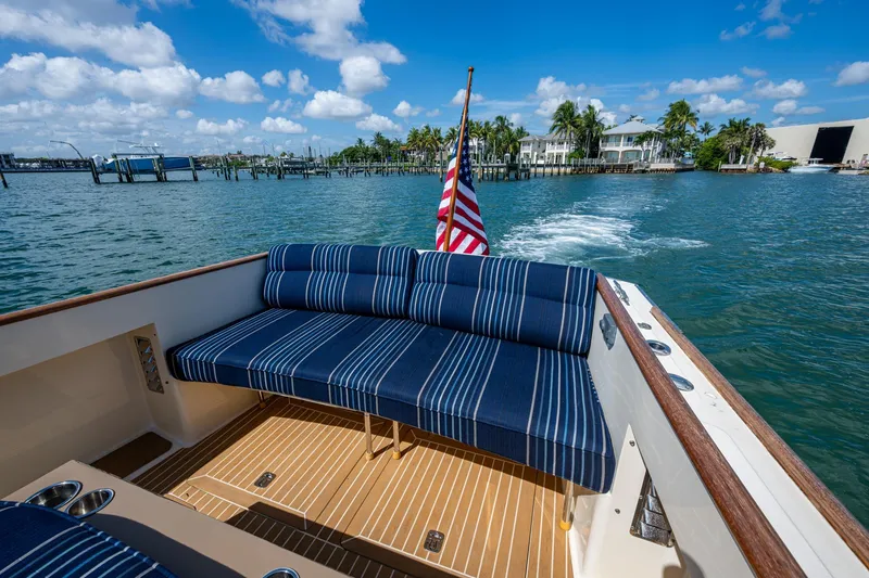 Slide: The Image of 2001 Hinckley Picnic Boat Classic with striped seating, cruising on a sunny day. - 20