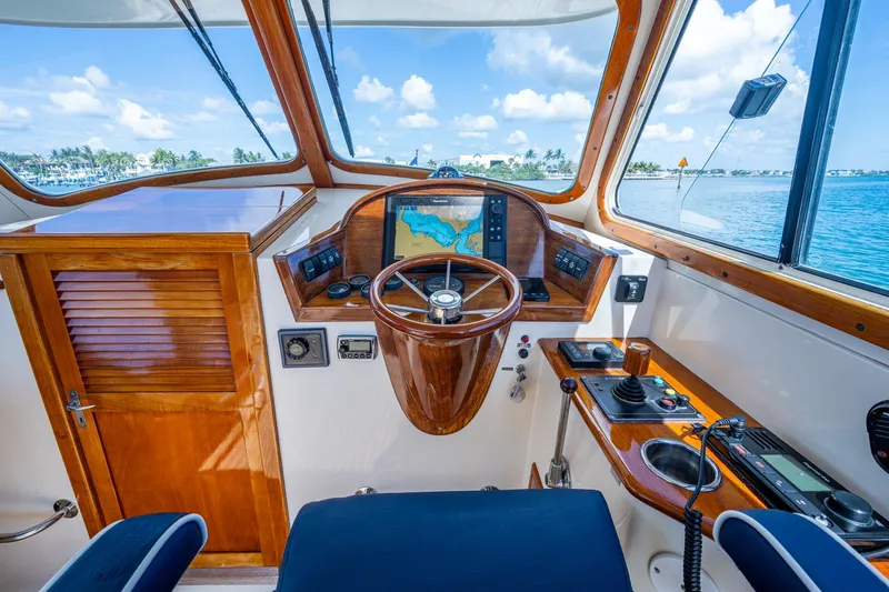 Slide: The Image of 2001 Hinckley Picnic Boat Classic helm with wooden steering wheel and navigation system. - 29