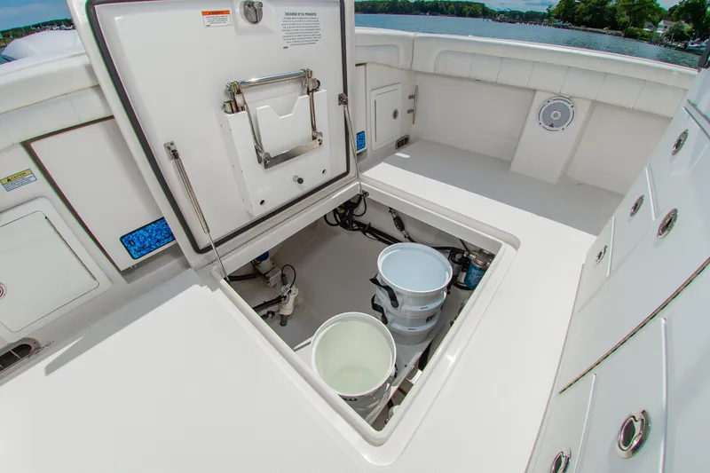 Slide: The Image of 2019 Regulator 31 boat storage compartment with open hatch and buckets. - 29
