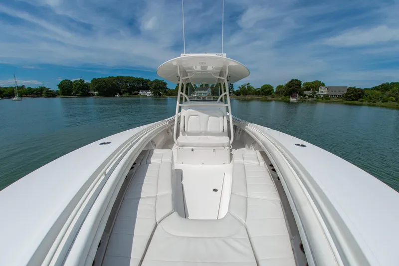 Slide: The Image of 2019 Regulator 31 boat on calm water, featuring spacious seating and sleek design. - 36