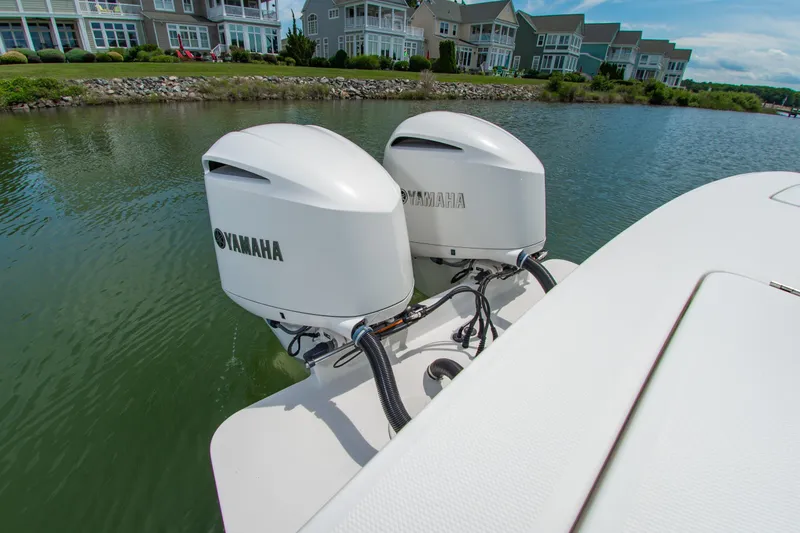 Slide: The Image of 2019 Regulator 31 boat with dual Yamaha outboard engines on a calm waterway. - 39