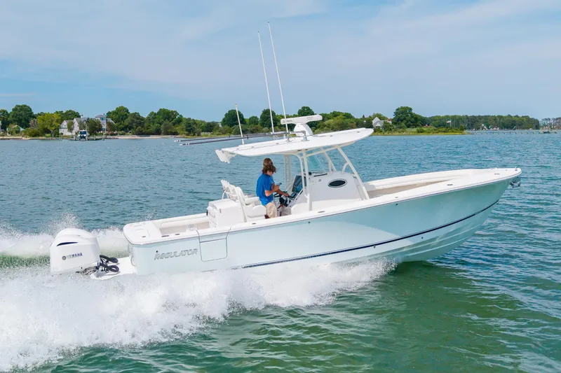 Slide: The Image of 2019 Regulator 31 boat cruising on a sunny day with Yamaha engine. - 45
