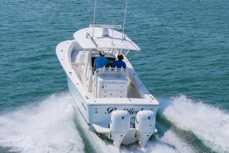 Slide: The Image of 2019 Regulator 31 boat cruising on open water with twin engines. - 51