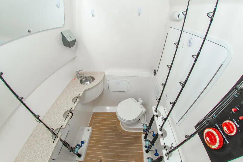 Slide: The Image of 2019 Regulator 31 boat interior with sink, toilet, and fishing rod holders. - 8