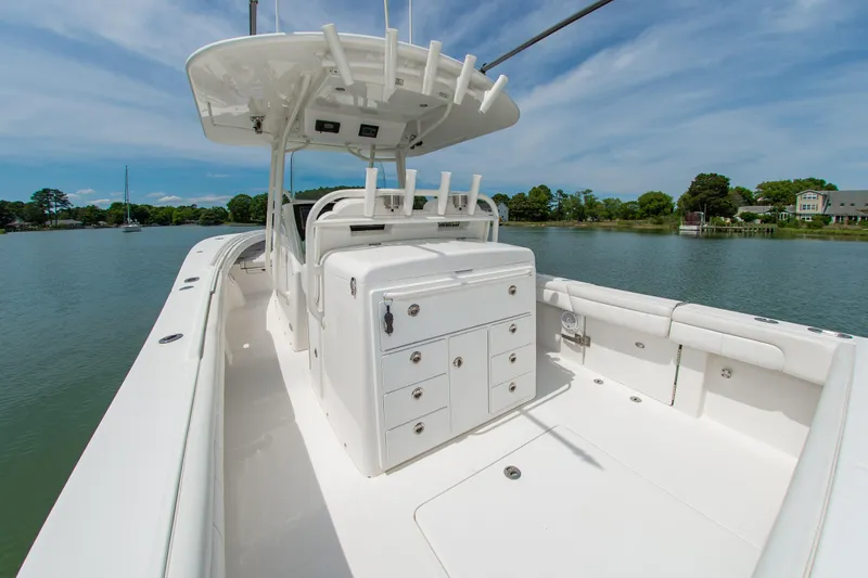 Slide: The Image of 2019 Regulator 31 boat with spacious deck and storage, docked on a serene lake. - 9