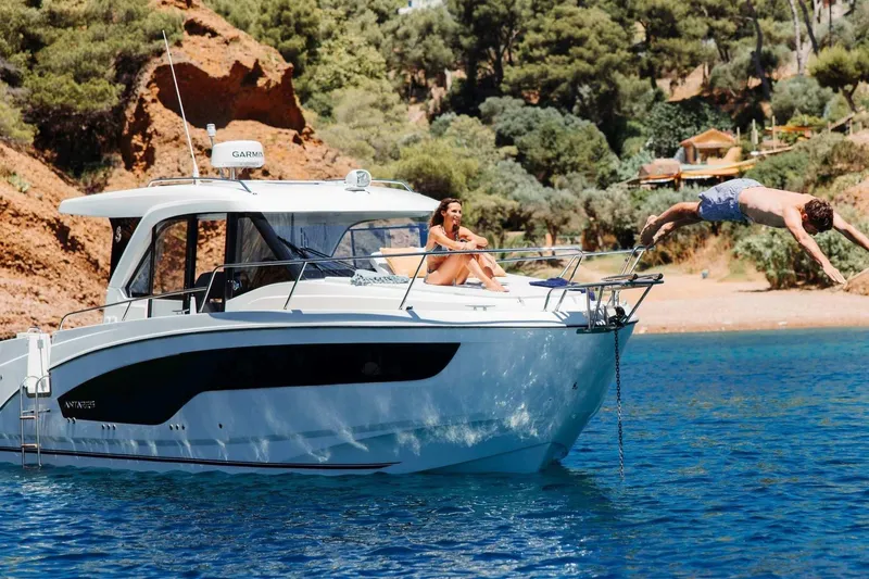The Image of 2027 Beneteau Antares 9 yacht with people enjoying a sunny day on the water. - 0
