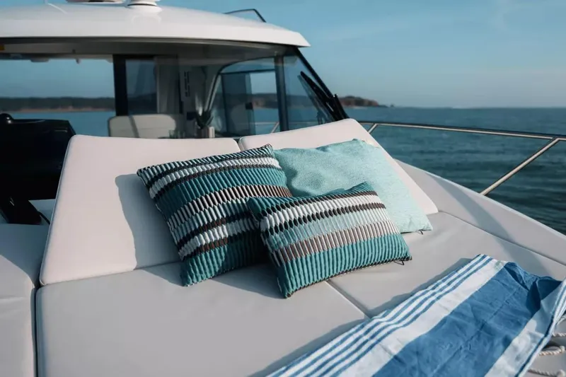 Slide: The Image of Luxurious Beneteau Antares 9 yacht deck with cushions, 2027 model, ocean view. - 13