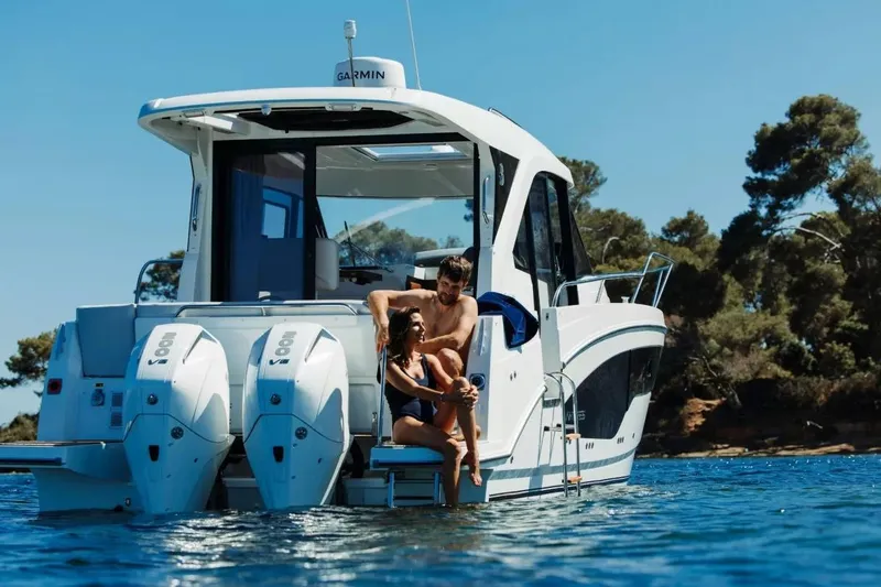 Slide: The Image of 2027 Beneteau Antares 9 boat with two people relaxing on the deck. - 3