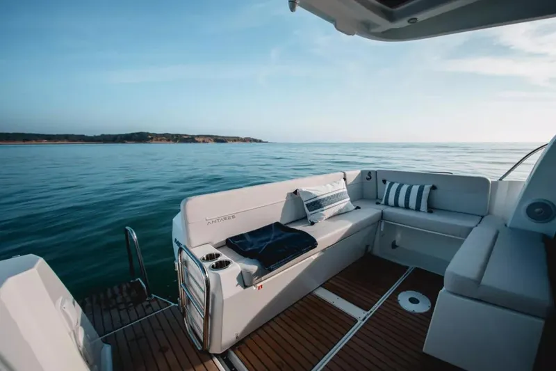 Slide: The Image of 2027 Beneteau Antares 9 boat deck with seating, overlooking calm ocean waters. - 6