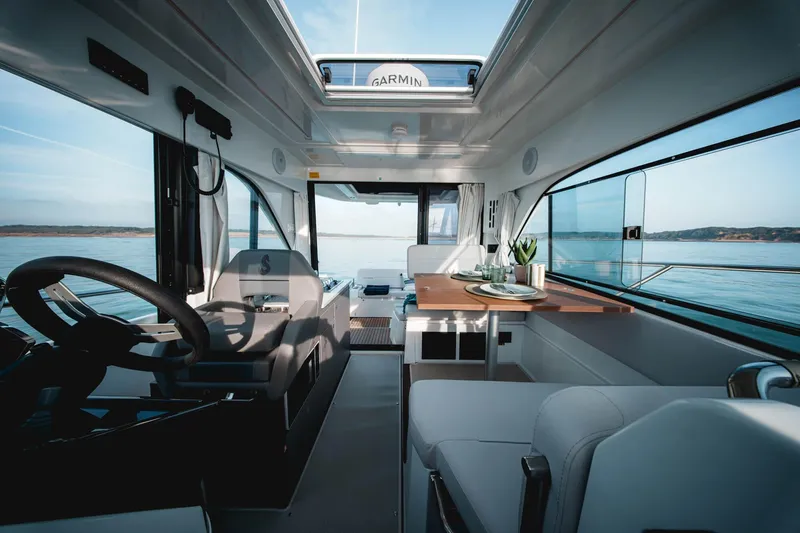 Slide: The Image of Interior of 2027 Beneteau Antares 9 boat, featuring modern design and panoramic windows. - 9
