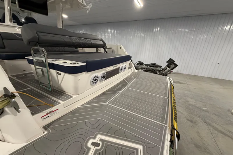 Slide: The Image of 2027 Regal 38 Surf boat interior with seating and speakers in a garage setting. - 14