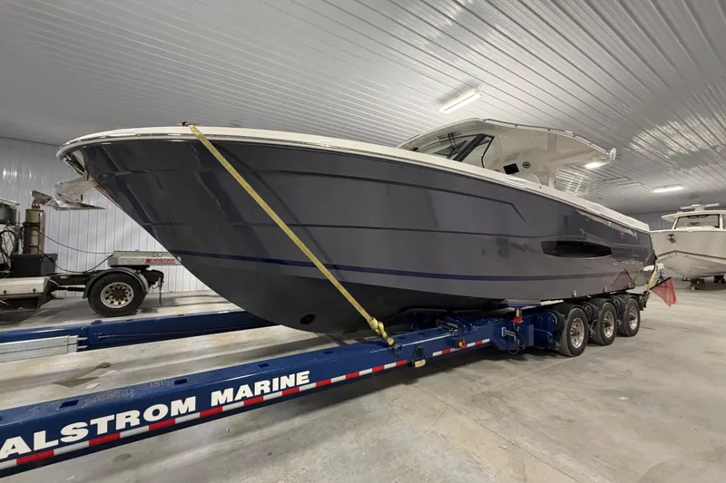 Slide: The Image of 2027 Regal 38 Surf boat on trailer in indoor storage facility. - 15