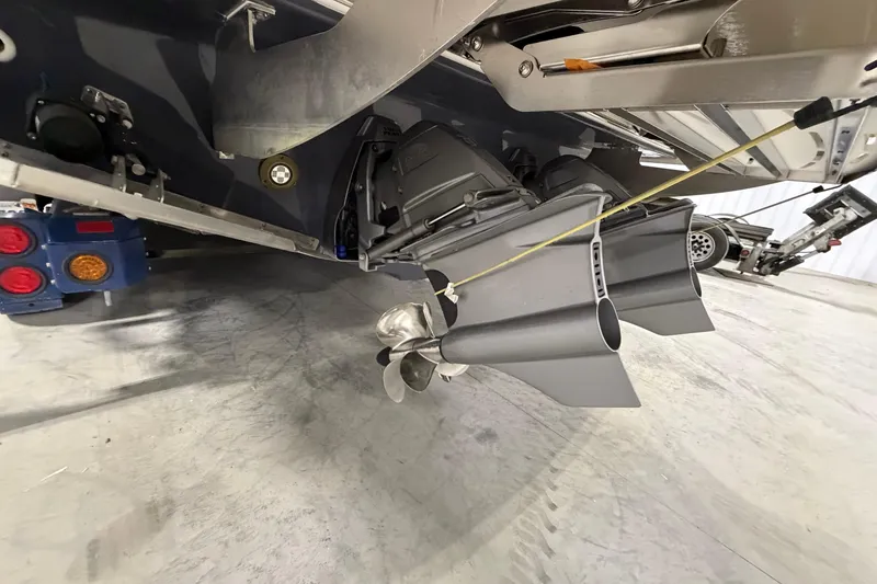 Slide: The Image of 2027 Regal 38 Surf boat's propulsion system and propeller detail in a garage setting. - 17