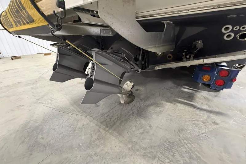 Slide: The Image of 2027 Regal 38 Surf boat's stern with dual propellers in a garage setting. - 18