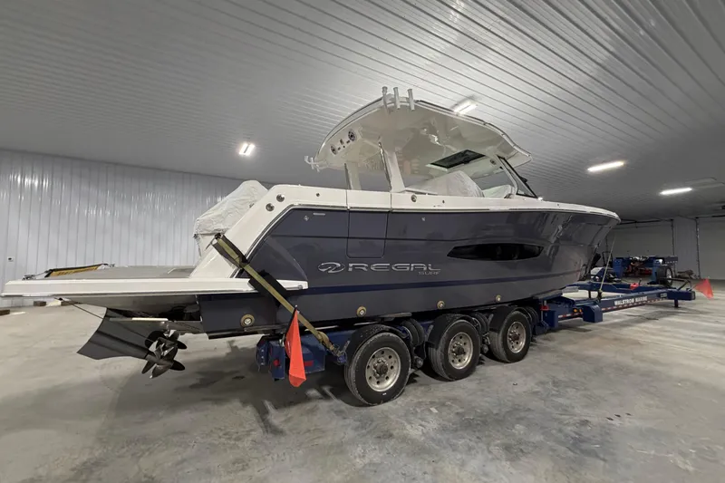 Slide: The Image of 2027 Regal 38 Surf boat on trailer in indoor storage facility. - 19