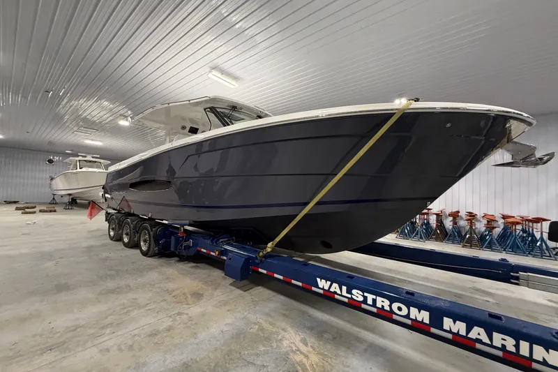 Slide: The Image of 2027 Regal 38 Surf boat on trailer in indoor storage facility. - 20