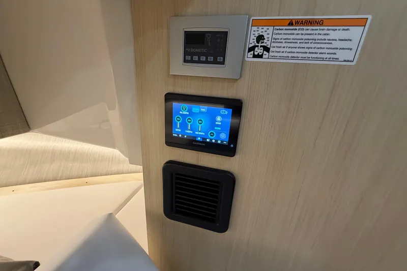 Slide: The Image of Control panel and warning label inside 2027 Regal 38 Surf boat cabin. - 23