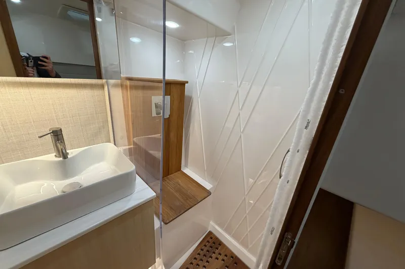Slide: The Image of Modern bathroom interior of 2027 Regal 38 Surf yacht, featuring sleek sink and shower. - 24