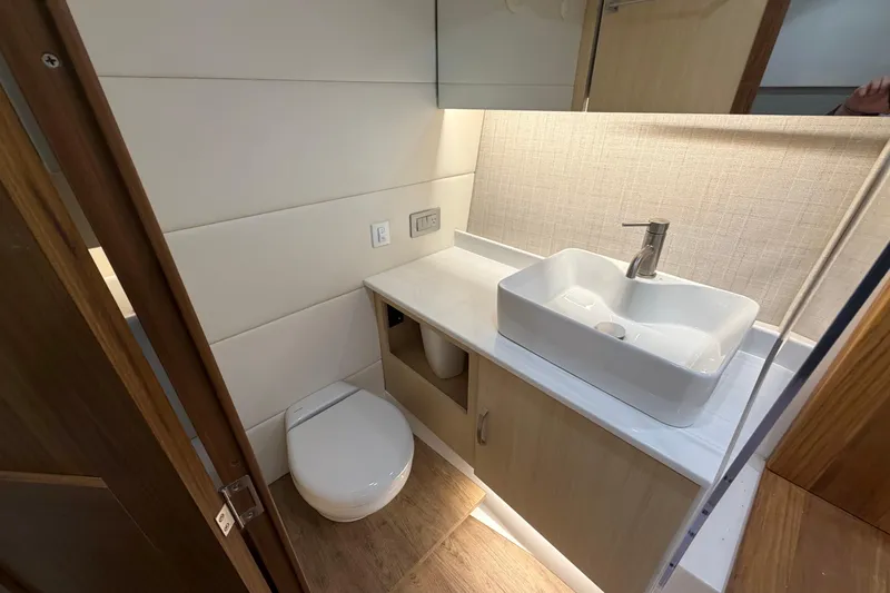Slide: The Image of Modern bathroom in 2027 Regal 38 Surf boat with sleek sink and toilet. - 25