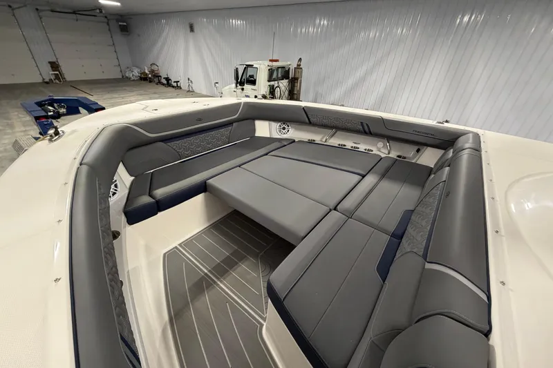 Slide: The Image of Luxurious interior of 2027 Regal 38 Surf boat with spacious seating in a garage. - 27