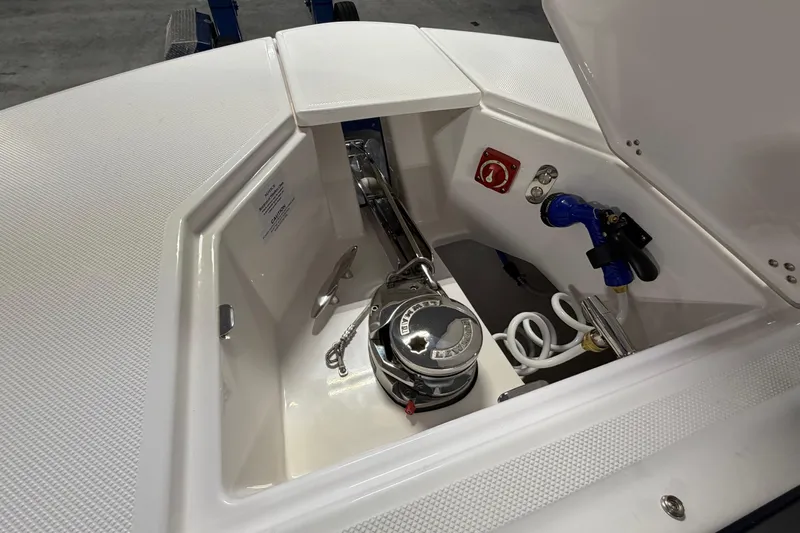 Slide: The Image of 2027 Regal 38 Surf boat anchor compartment with winch and hose connections. - 28