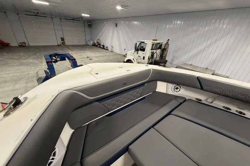 Slide: The Image of 2027 Regal 38 Surf boat interior in a spacious garage setting. - 29
